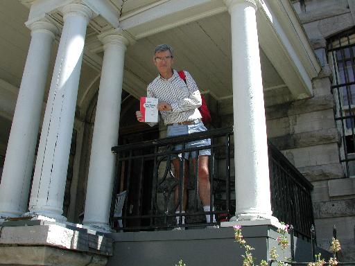 Joe holding Policy Routing book in front of the Ottawa Jail